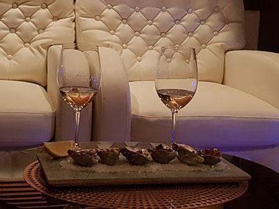 Oysters and wine in yacht cabin