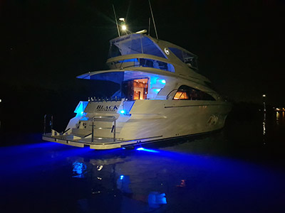 Black Diamond Yacht at night with blue lights.